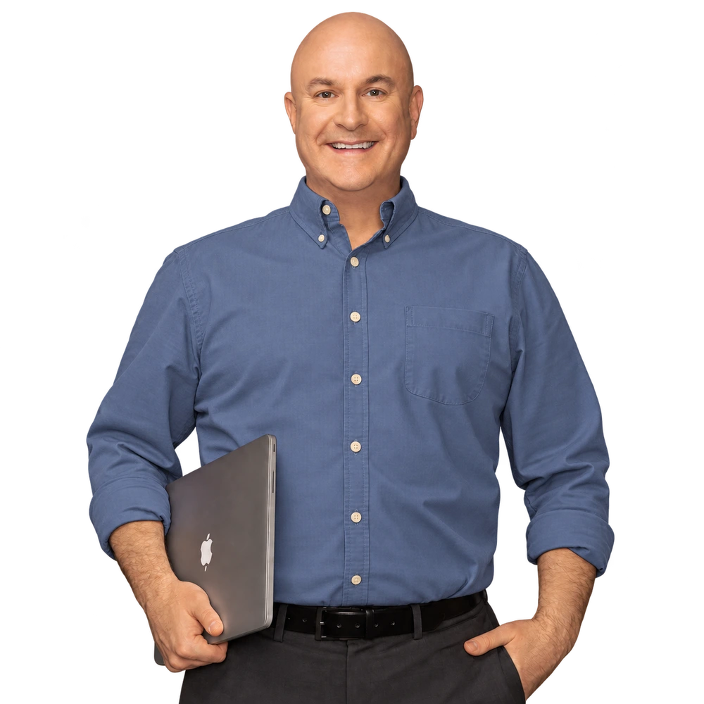 Brian Hurley smiling and holding a laptop